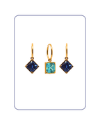 Gold earrings with blue and turquoise gemstones on a white background