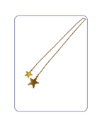 Gold star-shaped pendant on a thin chain against a white background